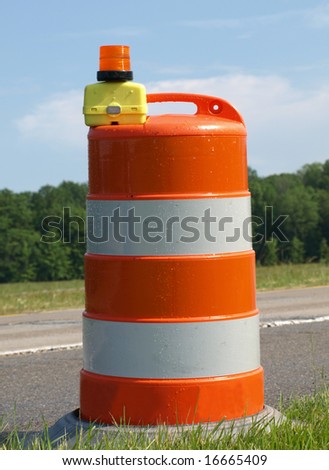 Single orange and White construction barrel
