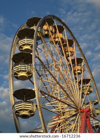 Ferris wheel isolated against beautiful sky with clouds