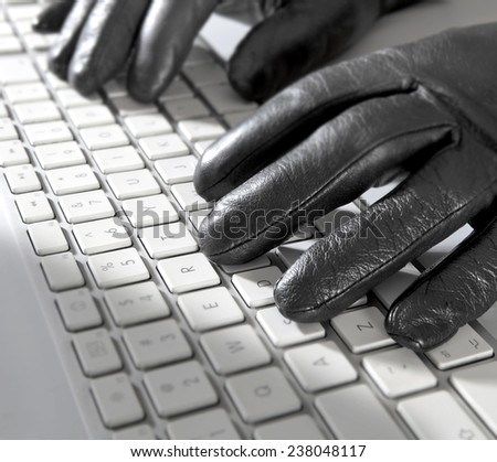 Computer keyboard with hands in black gloves