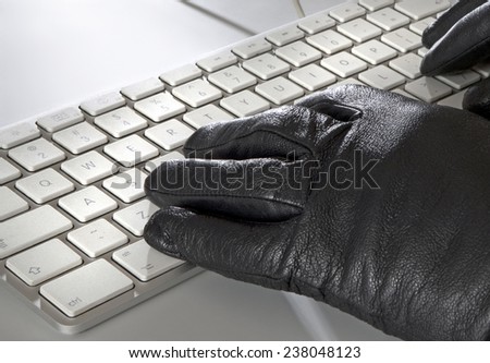 Computer keyboard with hands in black gloves