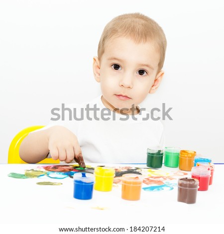 charming little boy learns to draw