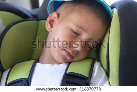 Portrait of a sleeping baby in the car seat.