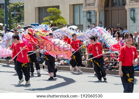 YOKOHAMA, JAPAN - MAY 3, 2014: Chinese students are performing a dragon dance on the street in 