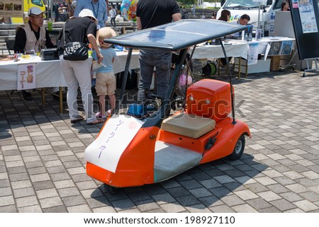 YOKOHAMA, JAPAN - May 31, 2014: A solar car is displayed in front of the booth of an NPO called \