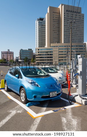 YOKOHAMA, JAPAN - OCTOBER 13, 2013: Electric cars (Nissan Leaf) are parked at a parking lot in Yokohama, Japan. These are used for car sharing which is operated by ORIX Auto Corporation.