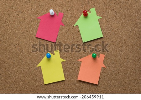 House-shaped memo pad on the cork board