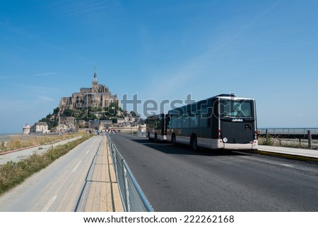 MONT SAINT-MICHEL, FRANCE - JULY 26, 2014: Shuttle buses used to access the Mont Saint-Michel. Shuttle buses are only vehicles allowed to approach this World Heritage Site.