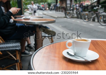 Coffee cup on the table at a cafe in Paris, France.