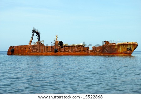 The Ship aground.The Rusty ship beside coast of the island Sakhalin. The Pacific ocean