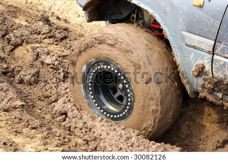 Wheel of the car in dirt.