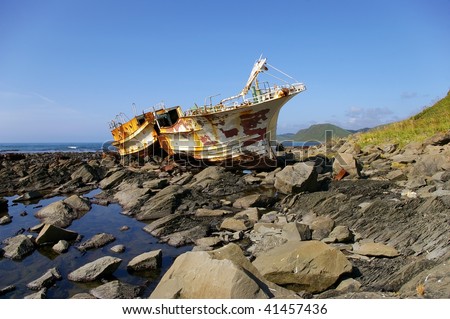 Splitting fishing schooner on stone . Island Sakhalin