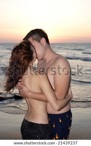 stock photo Romantic couple kissing at seaside on sunset
