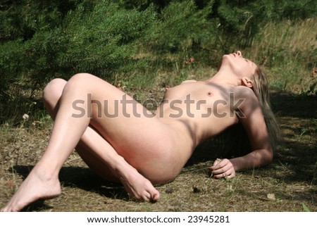 stock photo Beautiful nude girl lies on a glade