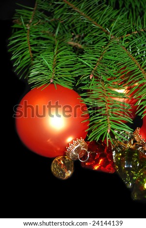 The vertical Christmas composition with orange ornament and magic crystals isolated on the black background.