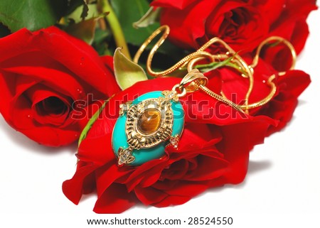 Blue gold Pendant on the red rose with gold chain isolated on the white