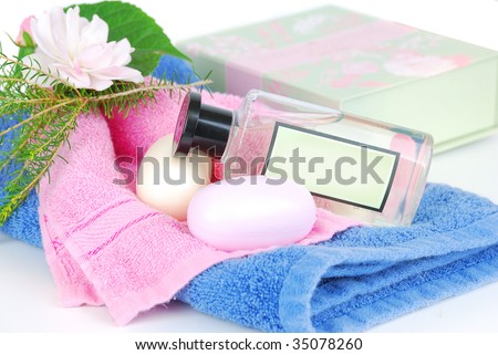 Spa accessories: shower gel, towel, soap, green box with natural floral isolated on the white.