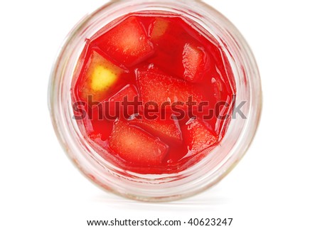 Fruit berry  jelly in the glass cans with apples and pears peaces isolated on the white.