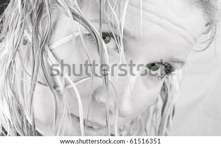 Woman with wet hairs and green eyes looking in camera. Waiting, interesting, strange, looks as weetch.