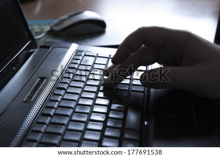 human fingers on the notebook keyboard close-up