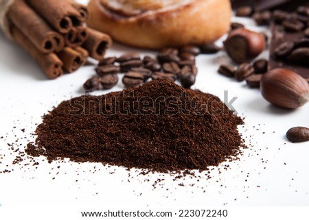 handful of ground coffee close up on a white