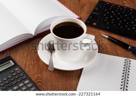 business still life with cup of black coffee on desktop