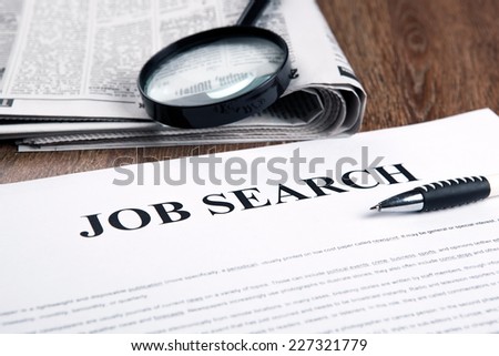 document with the title of job search with newspaper closeup