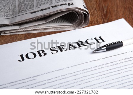 document with the title of job search with newspaper closeup