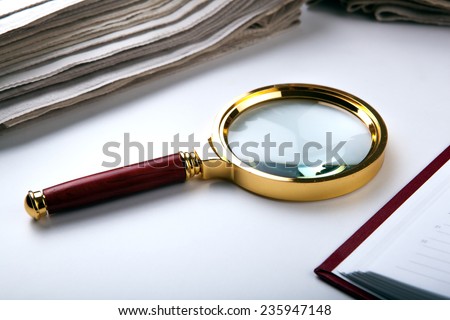 magnifying glass and paper close up