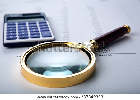 work with a magnifying glass, a calculator and papers