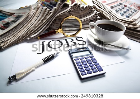 title jobs with loupe, pen, newspapers, cup of coffee and calculator