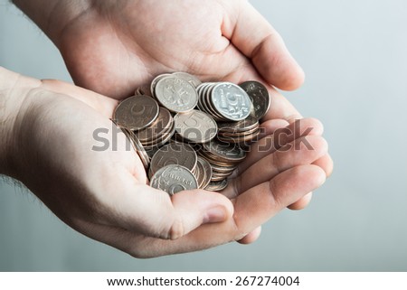 five-ruble coin in man\'s hands close up