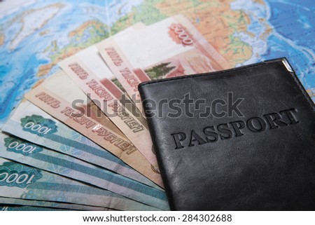 passport in the bag on a map with bank notes close up