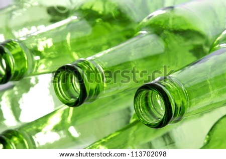 Bunch of empty glass beer bottles with back lighting.