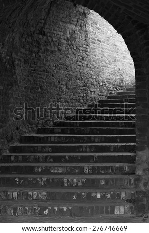 Black and white old rustic gothic brick stairway tunnel at Petrovaradin, Novi Sad, Serbia.