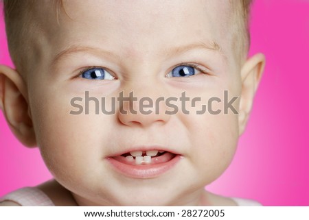 smiling baby girl in pink background