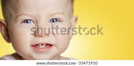 smiling baby girl in yellow background