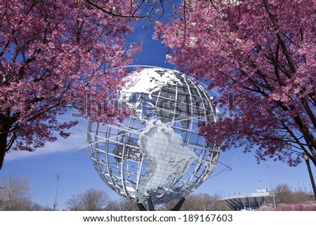 NY - APR 20, 2014: The Unisphere with cherry blossom trees in Flushing Meadows Corona Park at New York City.