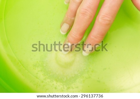 Female hand in the water