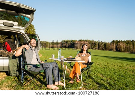Camping car happy couple enjoy sun relax picnic in countryside