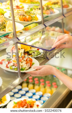 Fresh salad buffet self-service food display human hand take plate