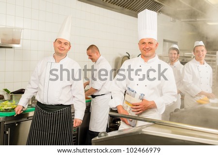 Professional kitchen busy team cooks and chef prepare meal