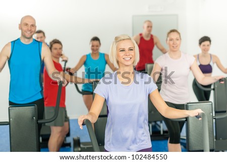 Fitness young group on treadmill running trainer at health gym