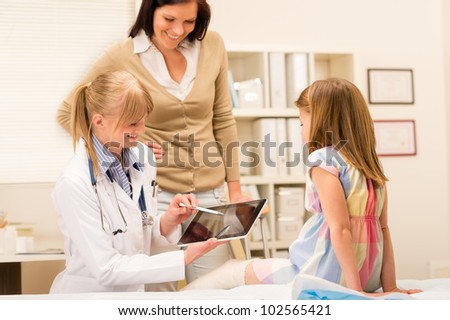 Pediatrician point at tablet x-ray girl broken leg medical office