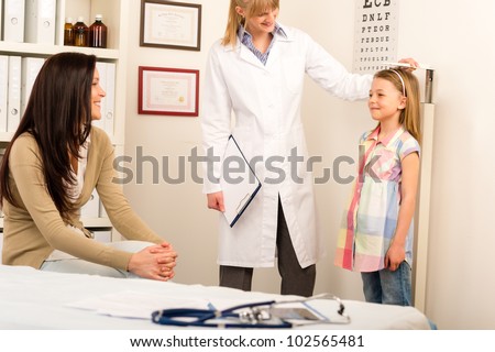 Medical examination at pediatrician girl measure height and weight