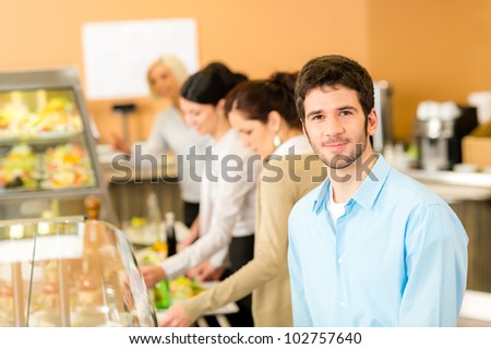 Business man take cafeteria lunch food from display cabinet self-service