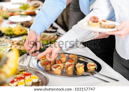 Catering at business company event people choosing buffet food appetizers