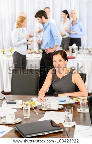 Business woman at company event work during buffet lunch
