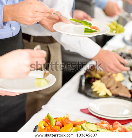 Business catering people take buffet food during company event