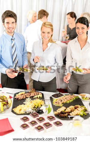 Company meeting catering smiling business people eat buffet appetizers