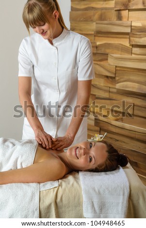 Woman getting massage treatment in luxury health spa centre